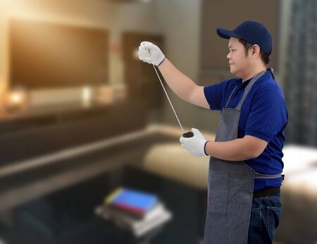 Craftsman home renovation working with Measuring Tape and blurred background of living roomの写真素材