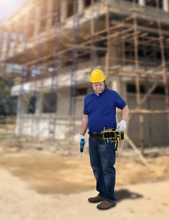Portrait of Male Construction foreman supervisor or worker with Protection Equipment and blurred background is construction siteの写真素材