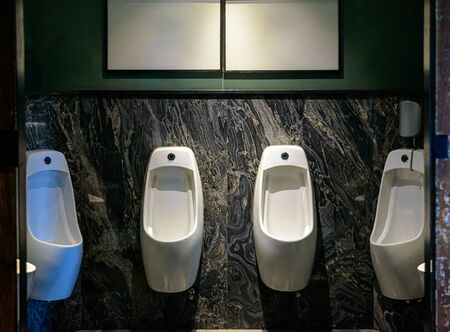 Row of urinal in Empty public men toilet in modern styleの写真素材