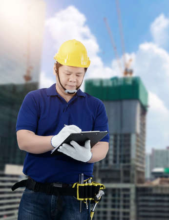 Male Building contractor Sign the signature on the Construction progress form Blurred the background of the warehouseの写真素材