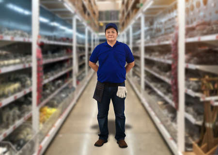 Portrait of male staff warehouse operator with Blurred the background of equipment tool for technician or worker on product shelf in Construction material storeの写真素材