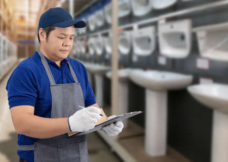 Portrait of male staff warehouse operator with Blurred the background of equipment tool for technician or worker on product shelf in Construction material storeの写真素材