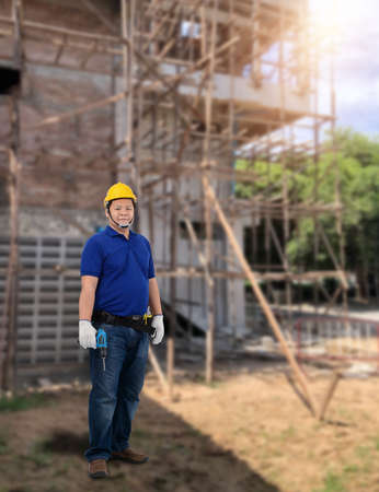Portrait of Male Construction foreman supervisor or worker with Protection Equipment and blurred background is construction siteの写真素材