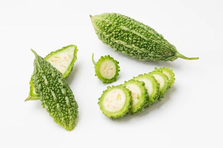 Momordica charantia fruit half and cut slice isolated on white backgroundの写真素材