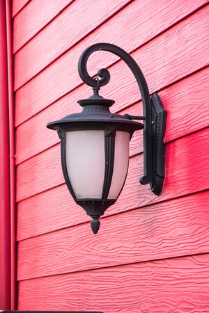Old lamp on red wood wallの写真素材