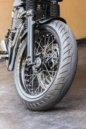 Motorcycle wheel in black and white with ABS brakes.