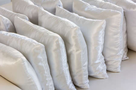white pillows leather on cushionの写真素材