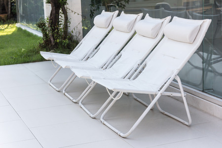 Lounge sunbeds near swimming pool, outdoor near seaの写真素材