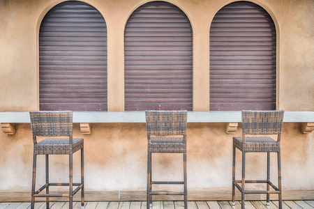 Front view of vintage wood room with a chair, windows and a door