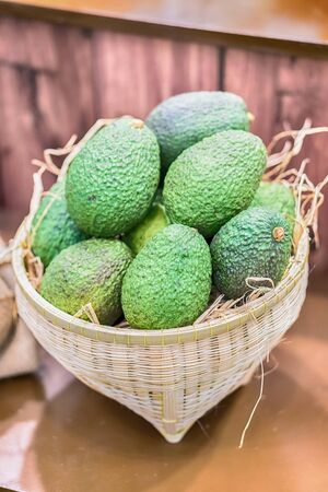 Avocado background. Fresh green avocado on a market stail. Food background.の写真素材