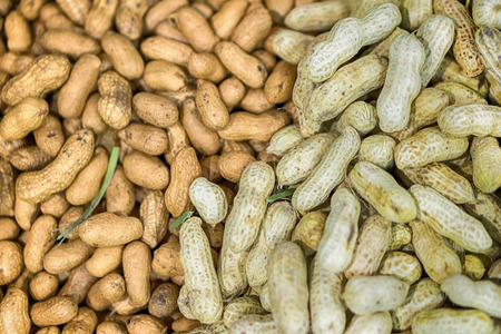 Peanuts in shell texture background. Raw peanuts on display at a farmer's market.