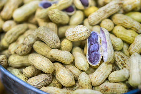 Peanuts in shell texture background. Raw peanuts on display at a farmer's market.