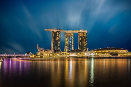 SINGAPORE - DECEMBER 10, 2016: The Helix Bridge, Marina bay sands & Artscience museum at night. Marina Bay Sand iconic design has transformed Singapore's skyline. Designed by architect Moshe Safdie.のeditorial素材