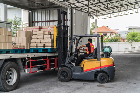 Worker loading pallet with a forklift into a truckのeditorial素材