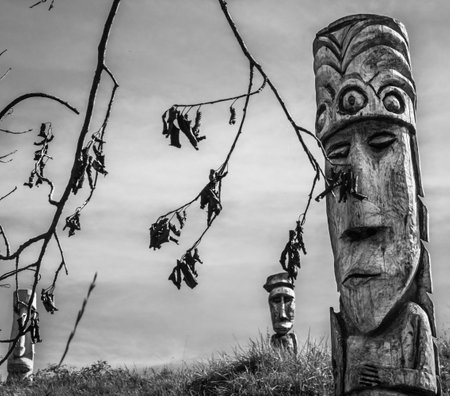 Moai carved in wood with blue sky backgroundの写真素材
