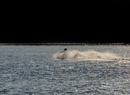 Two friends enjoying the jet ski skidding at high speed on Boiro beachの写真素材