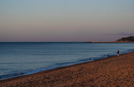 Sunrise with the first hours of the morning sun illuminating apartments and the Aro beach of the Mediterranean Sea.の写真素材