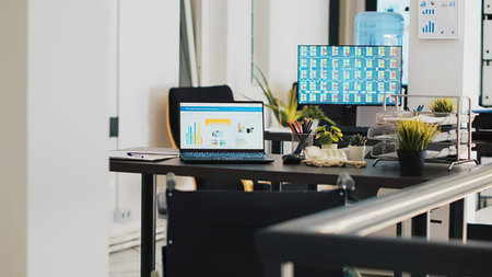 Modern office interior with computers and business items on table. Blurred background