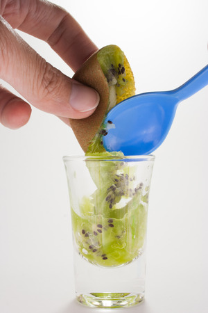 A half kiwi fruit with spoon ready to eatの写真素材