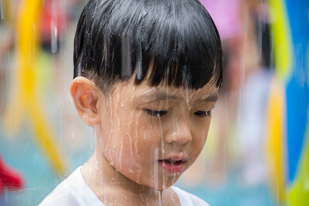 Boy playing in water park. Boy have fun in water park.の写真素材