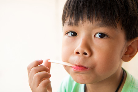 boy has satisfied when he eat favorite ice cream.の写真素材