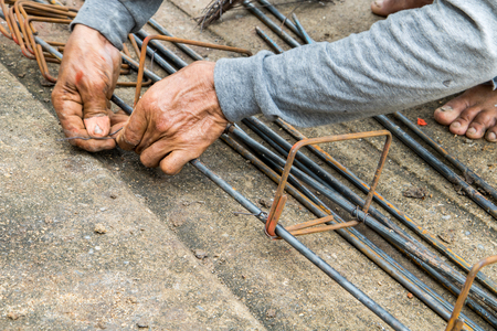 Labor is tying steel for construction site.の写真素材