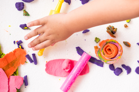 Children are molding colorful clay dough to various beautiful shape with imagination.の写真素材