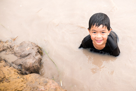 Little boy enjoy to playing clay slider at the countryside farm. He feels relaxing and fun.の写真素材