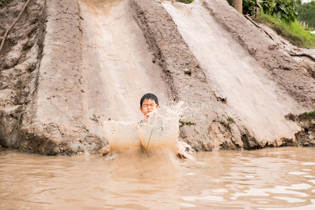 Little boy enjoy to playing clay slider at the countryside farm. He feels relaxing and fun.の写真素材