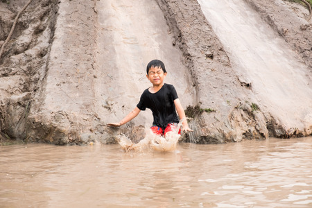 Little boy enjoy to playing clay slider at the countryside farm. He feels relaxing and fun.の写真素材