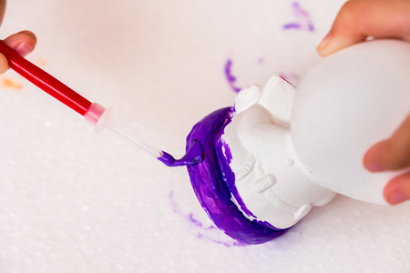 kids is painting the sculpture with colorful color. it's fun hobby for preschool children for learn about colors and shape.の写真素材