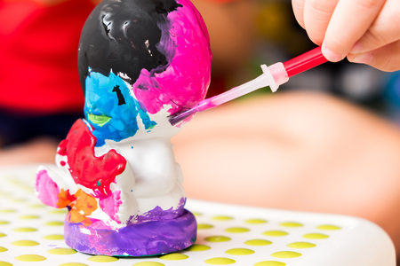 kids is painting the sculpture with colorful color. it's fun hobby for preschool children for learn about colors and shape.の写真素材