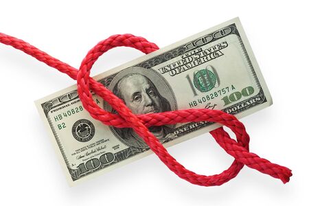 The red cord with figure-eight knot on a banknote. Isolated on white. Conception of risk or difficulty.の写真素材