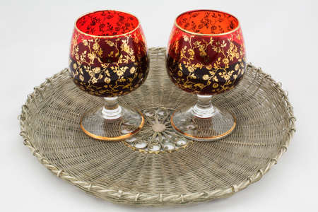 Two glasses with wine on a wattled metal trayの写真素材