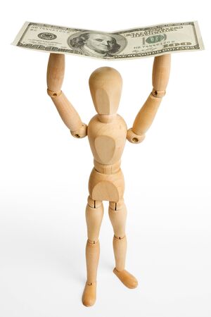 The wooden figure holds dollars.の写真素材