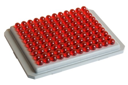 Red pills (capsules) on gray plate. 