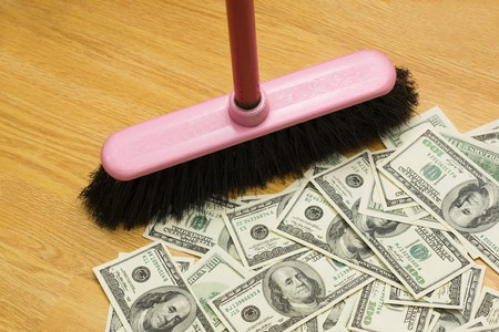 Broom, floor, heap of dollarsの写真素材