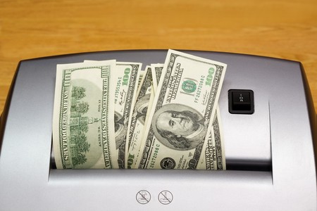 Shredder with heap of dollars (close up)の写真素材