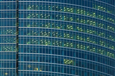 Wall of office building with empty cabinets and burning illuminationの写真素材