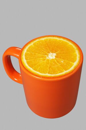 Orange mug with orange cut.の写真素材