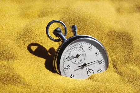 The old scratched stopwatch in yellow sand is covered by the sun. A metaphor of time.
の写真素材
