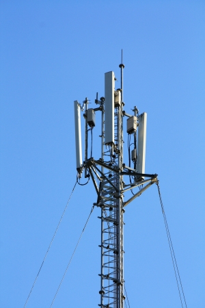 Telecommunications pole with blue skyの写真素材