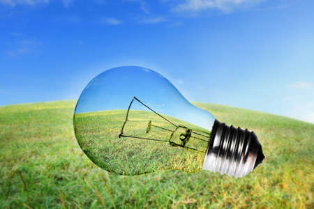Green grass and blue sky view in light bulbの写真素材