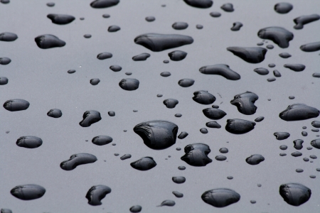 water drops on black surfaceの写真素材