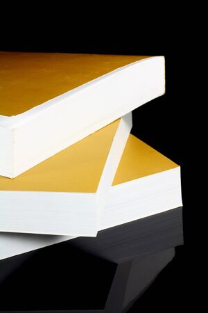three gold books on black backgroundの写真素材