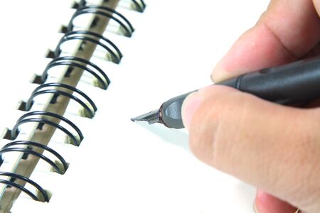 hand write black ink pen on the notebook