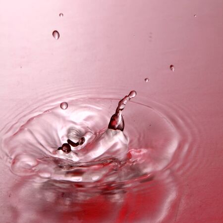 drop of water in red colorの写真素材