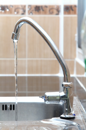 water tap and sink in kitchenの写真素材