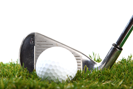 Golf club ready to hit golf ball on white backgroundの写真素材