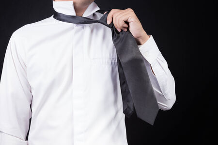 man putting on necktieの写真素材